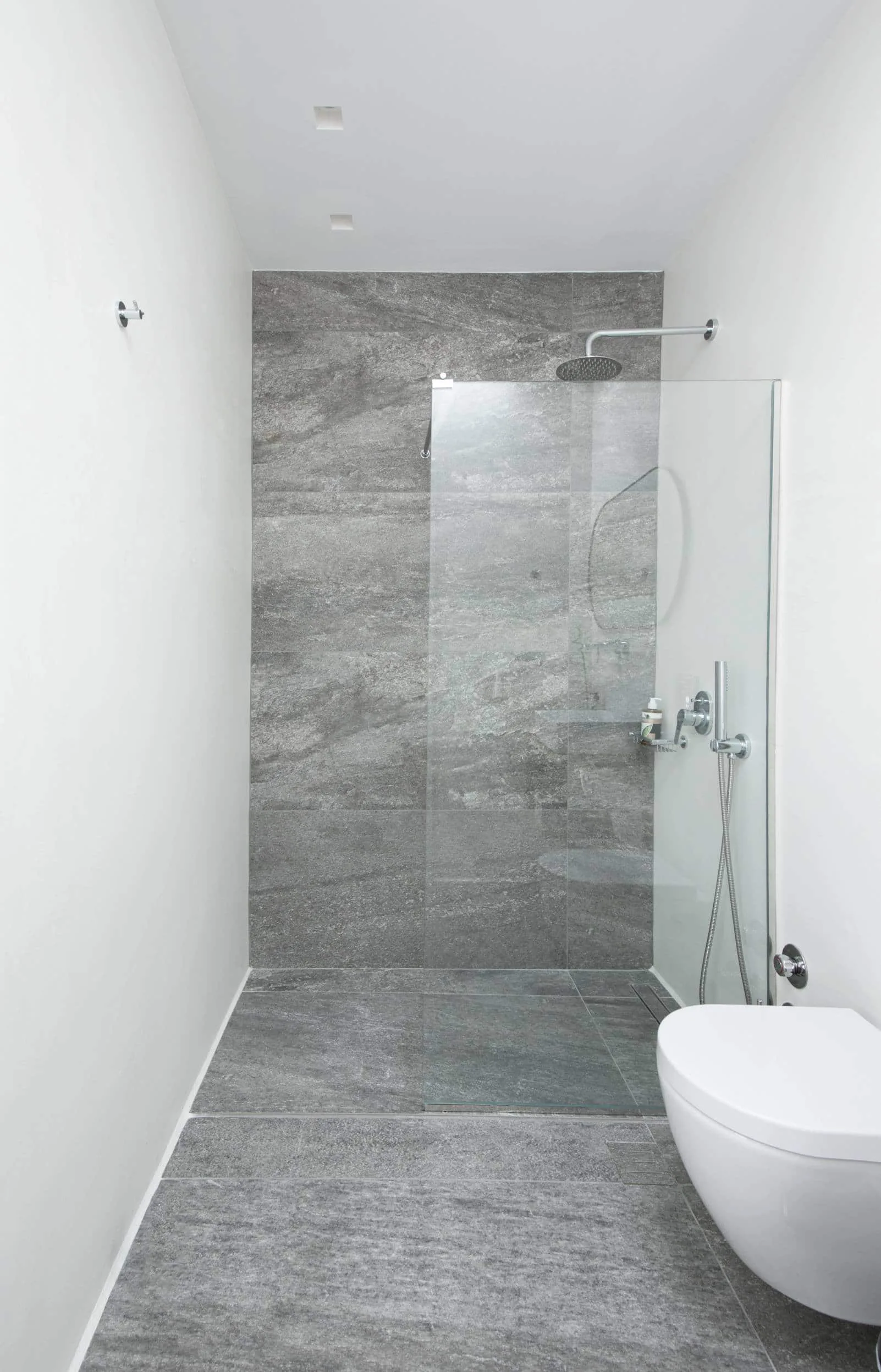 Walk-in shower with grey stone tiles
